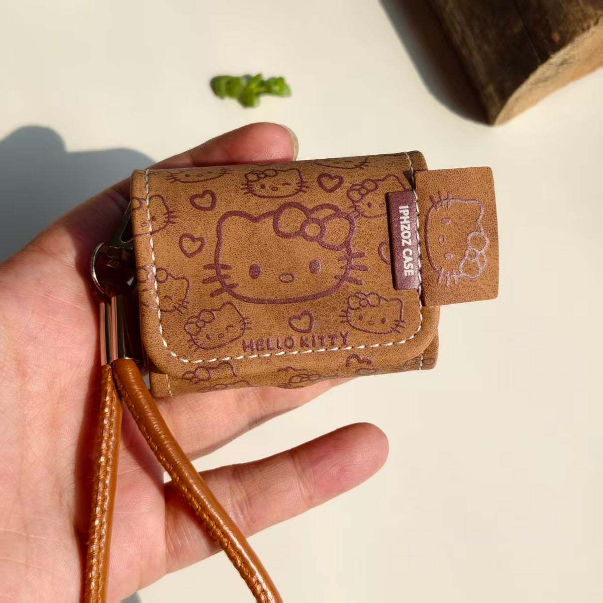 Vintage Brown Hello Kitty Leather AirPods Case with Wristlet Strap | Cute Cartoon Embossed Cover | Compatible with AirPods 1/2/3/Pro | 2026 Trending Kawaii Accessory