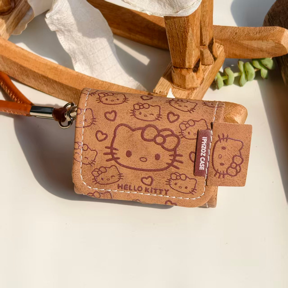 Vintage Brown Hello Kitty Leather AirPods Case with Wristlet Strap | Cute Cartoon Embossed Cover | Compatible with AirPods 1/2/3/Pro | 2026 Trending Kawaii Accessory